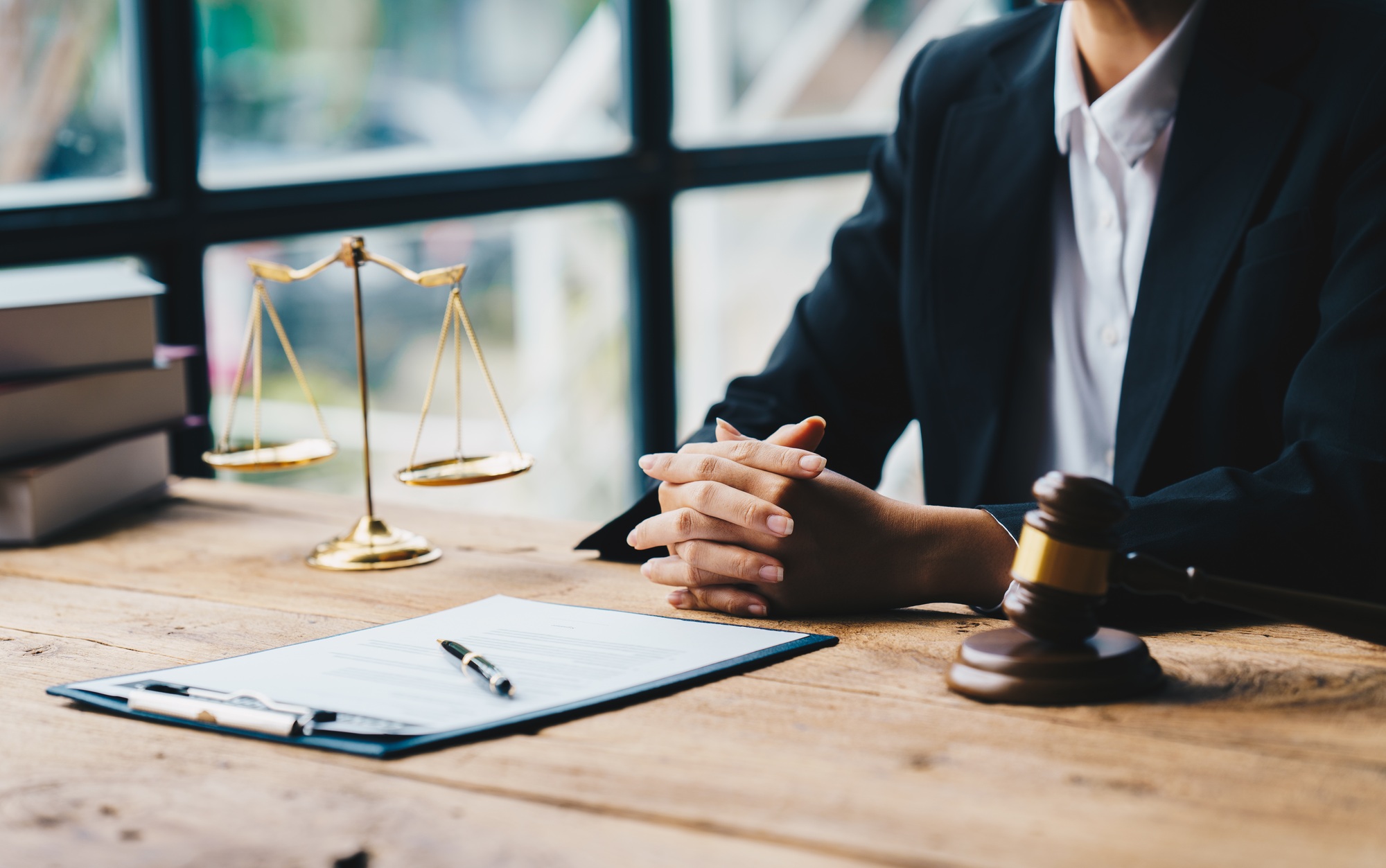 Businessman in suit or lawyer working on a documents. Legal law
