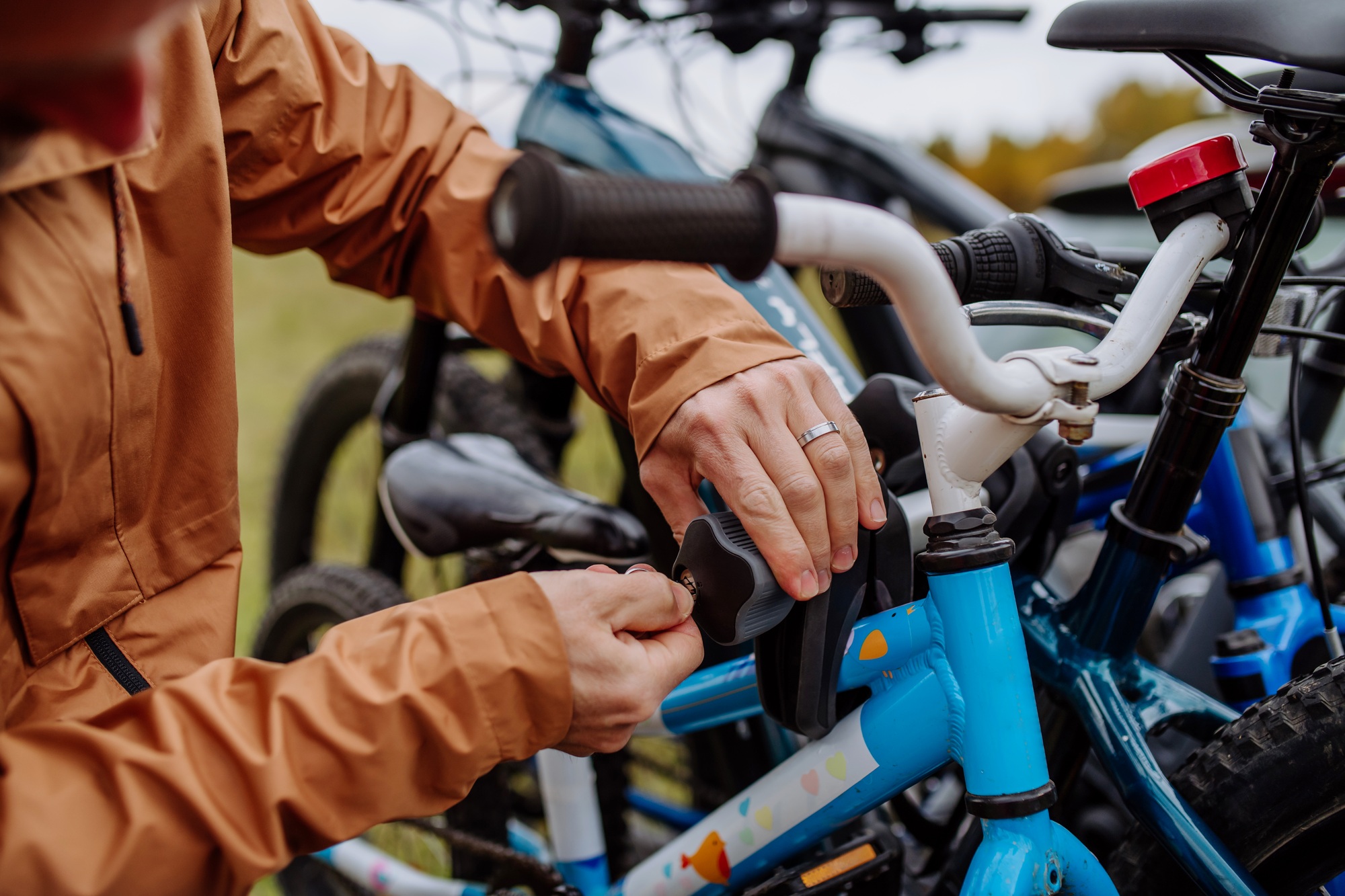 Close-up of putting bicycles on car rack.