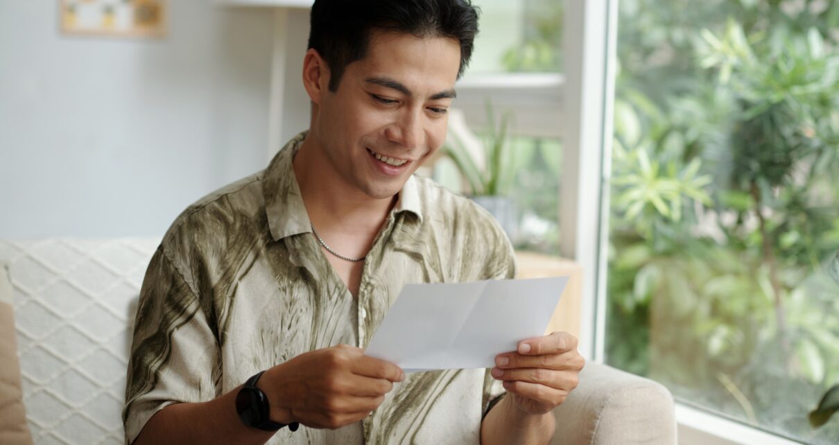 Man Reading Letter With Good News