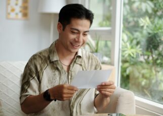 Man Reading Letter With Good News