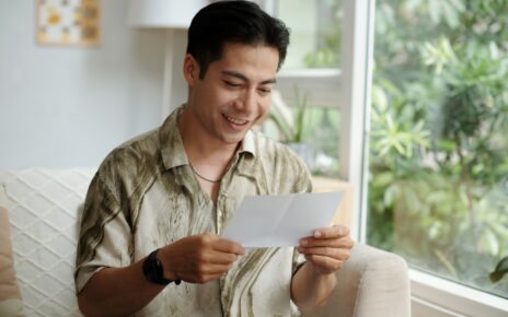 Man Reading Letter With Good News