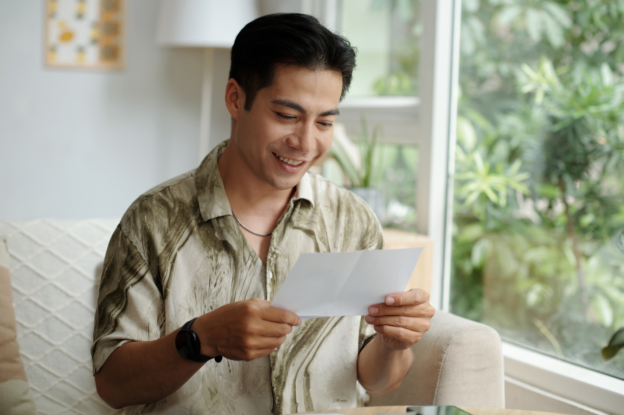 Man Reading Letter With Good News