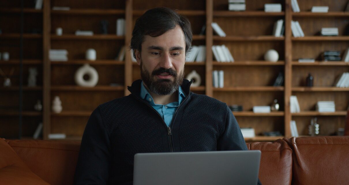 Mature Caucasian business man male businessman psychologist using laptop pc computer device talking