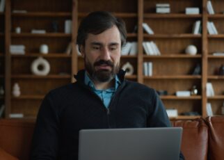 Mature Caucasian business man male businessman psychologist using laptop pc computer device talking
