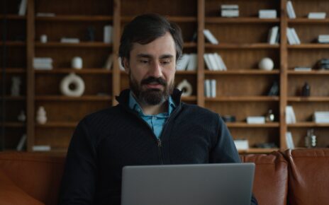 Mature Caucasian business man male businessman psychologist using laptop pc computer device talking
