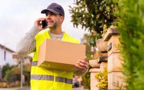 Package delivery carrier with a box from an online store, calling the customer