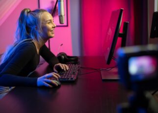Professional esport gamer girl streaming vlog and plays online video game on PC