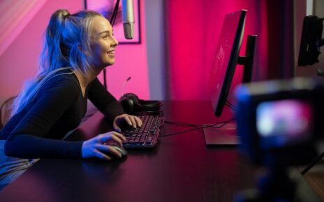Professional esport gamer girl streaming vlog and plays online video game on PC