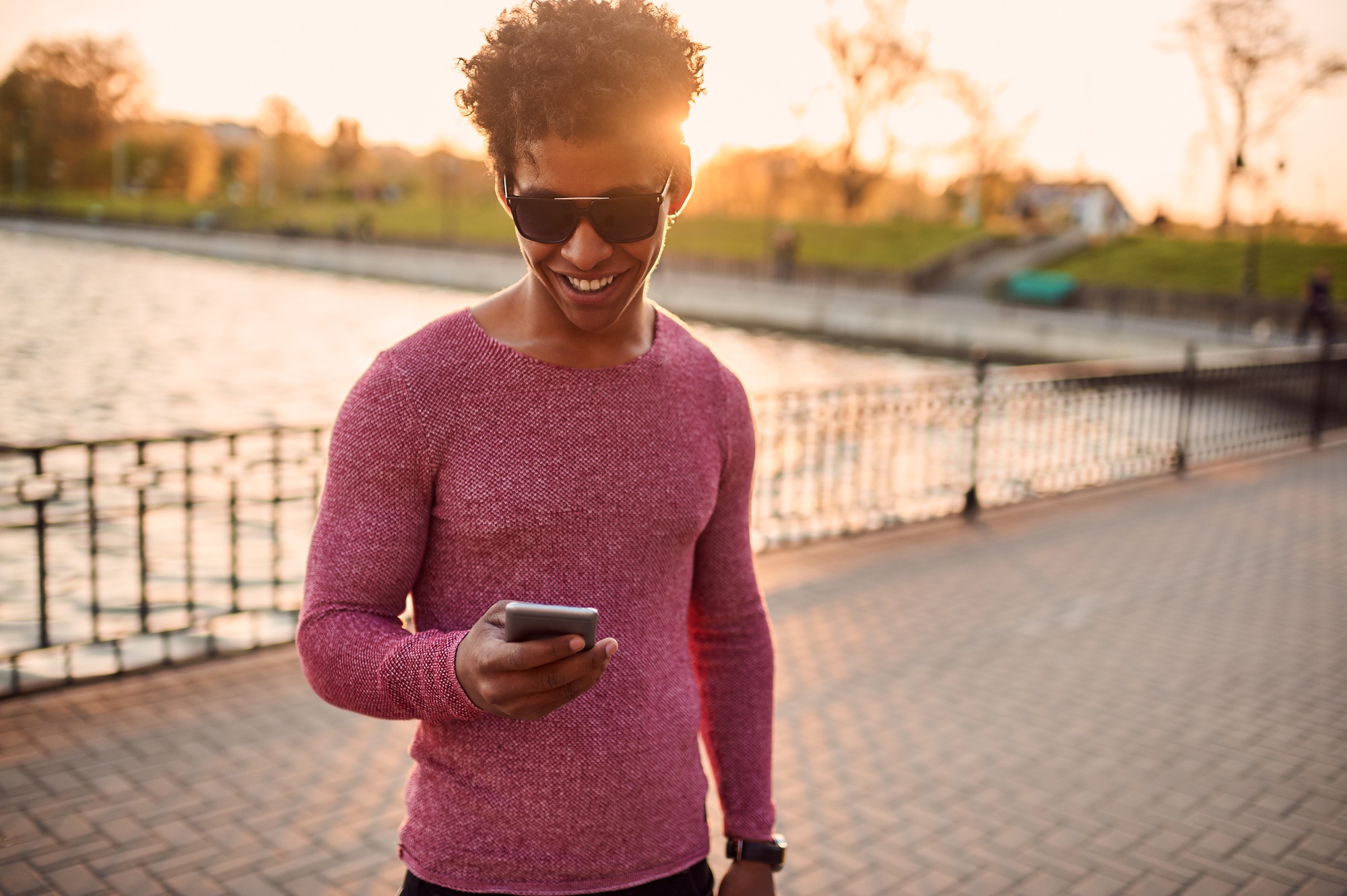 Young man writing sms outdoors with copy space