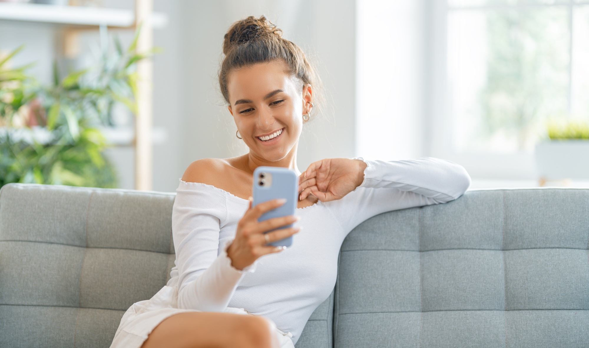 Young woman is using phone for video call