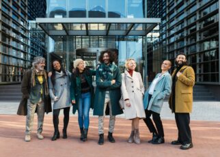 Diverse coworkers laughing on street before work together
