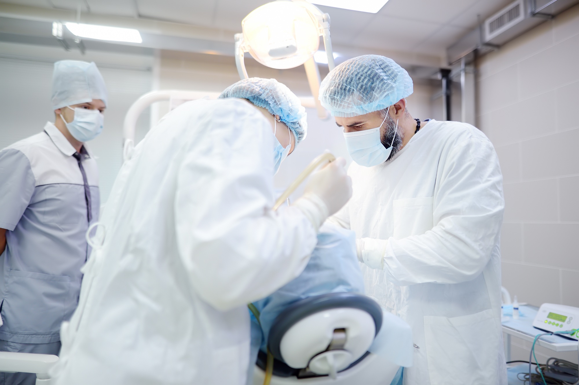 Surgeons and nurse during a dental operation.
