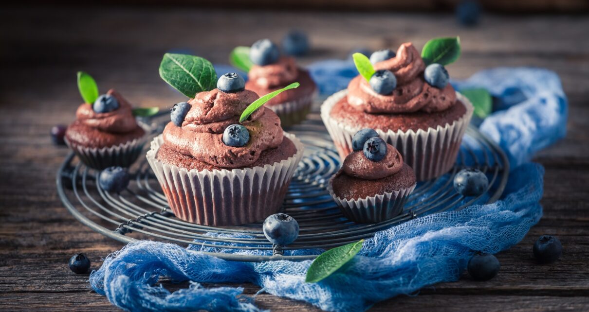 Tasty chocolate muffin with blueberries. Chocolate cupcake with fruit.