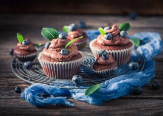 Tasty chocolate muffin with blueberries. Chocolate cupcake with fruit.