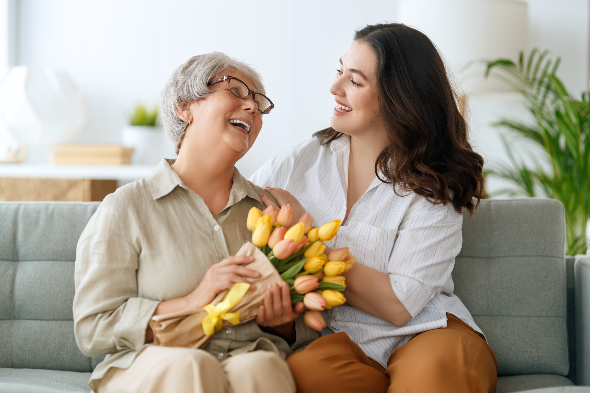 woman and her mother with flowers tulips