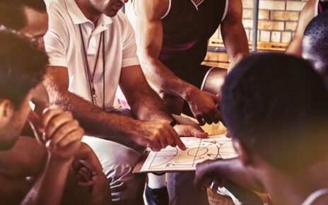Coach explaining game plan to basketball players