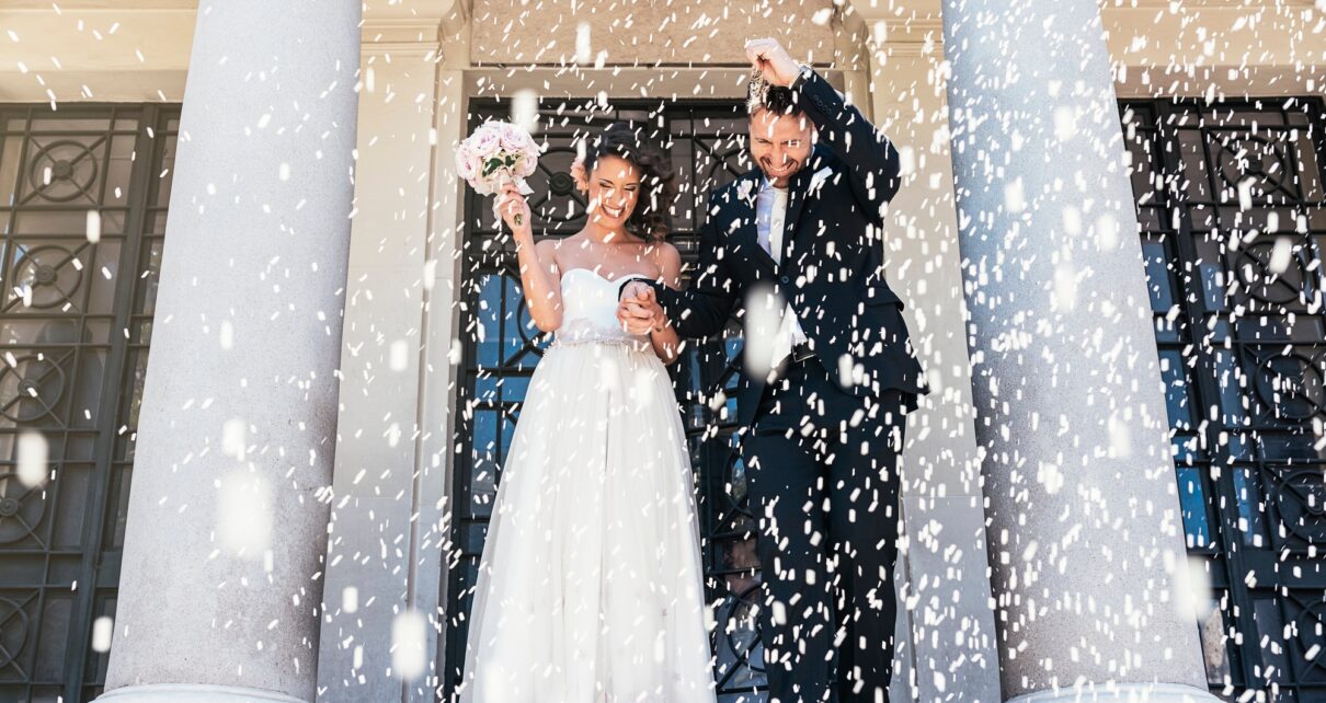 Newly married couple leaving the church.